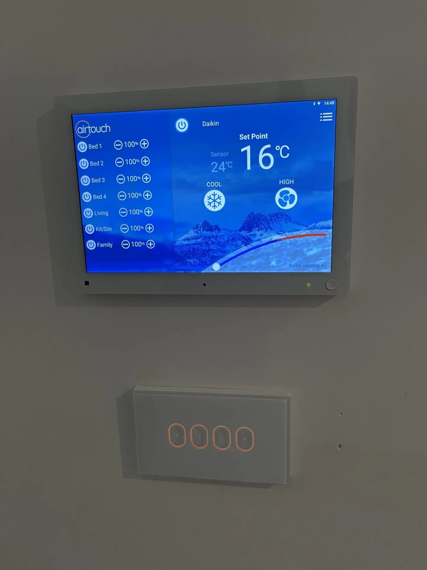 Installed AirTouch smart control touchscreen next to a Daikin wall controller