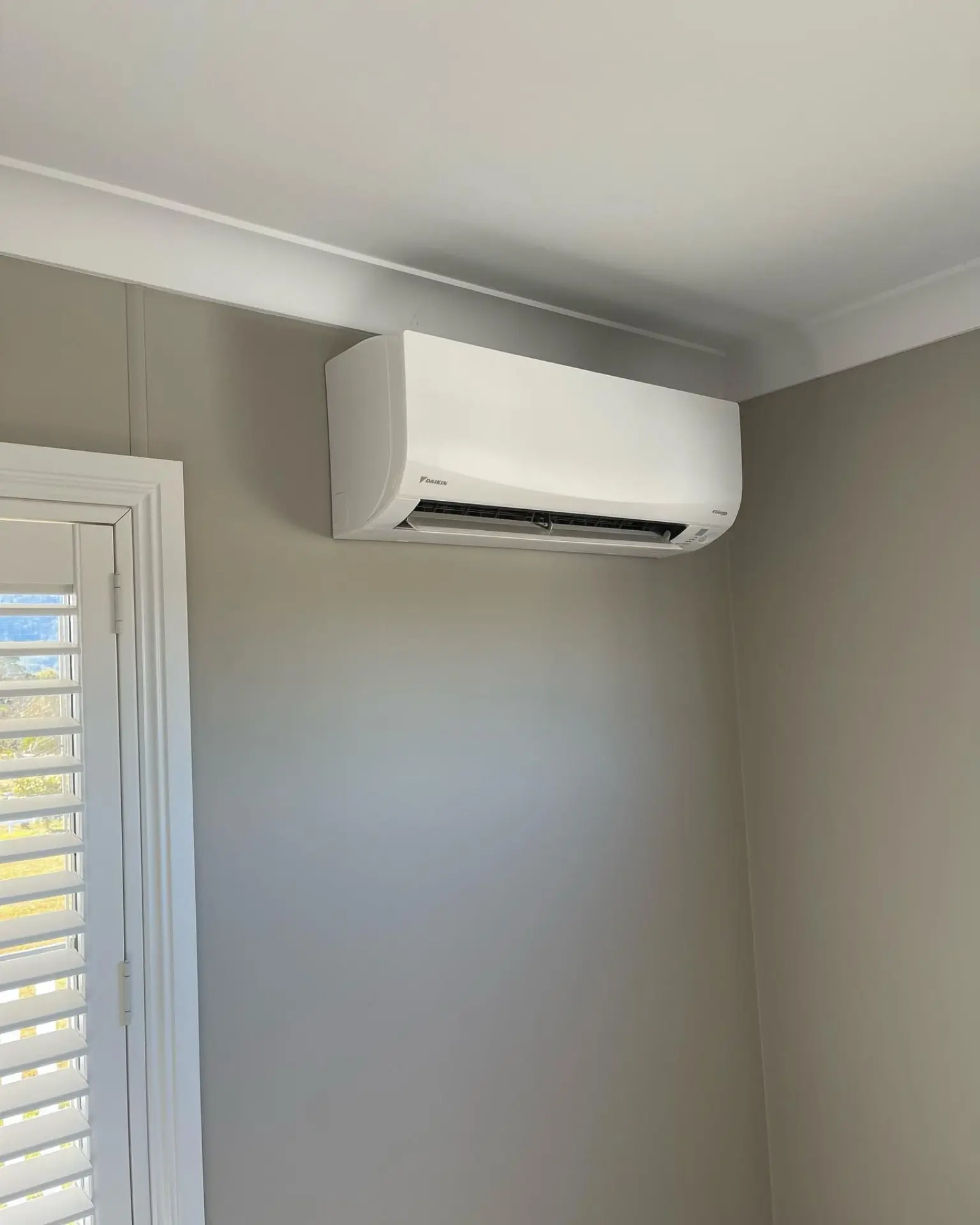 Daikin split system indoor unit installed on a bedroom wall