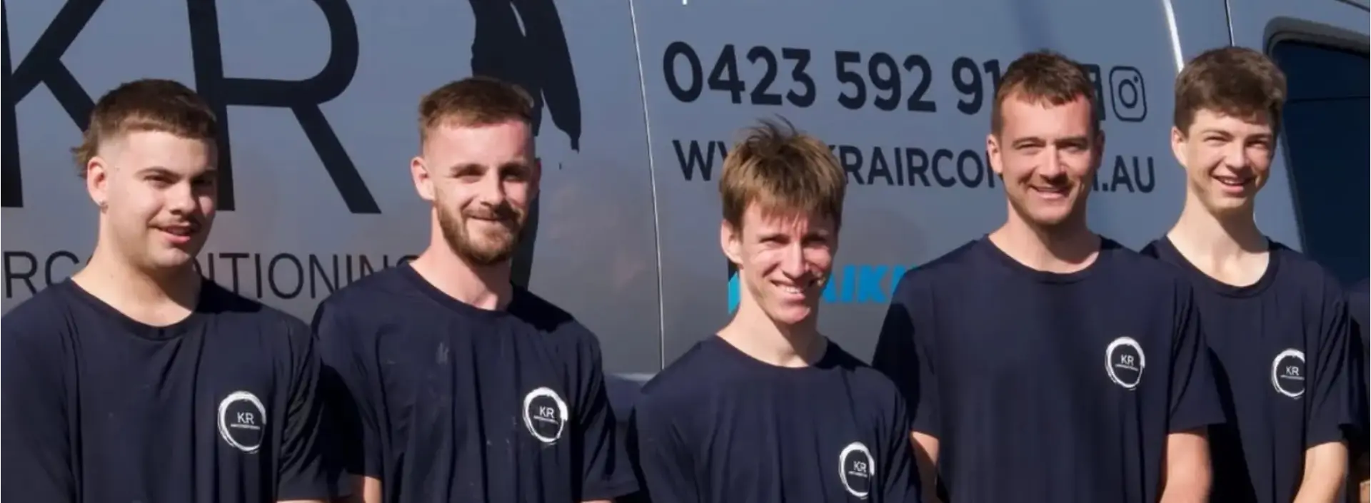 The KR Air Conditioning installation team in uniform beside their branded work van
